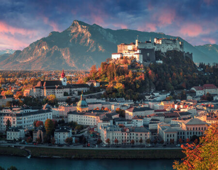 Colorful evening cityscape. Panoramic view on historic city of Salzburg with famous Hohensalzburg Fortress. Wonderful autumn landscape with picturesque sky. Softlight effect. Salzburger Land, Austria